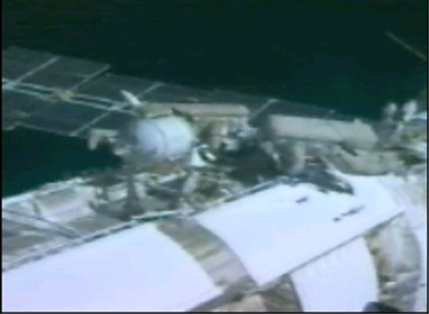 Padalka and Fincke replace a part on the coolant system during one of three EVAs. Image credit Space.com