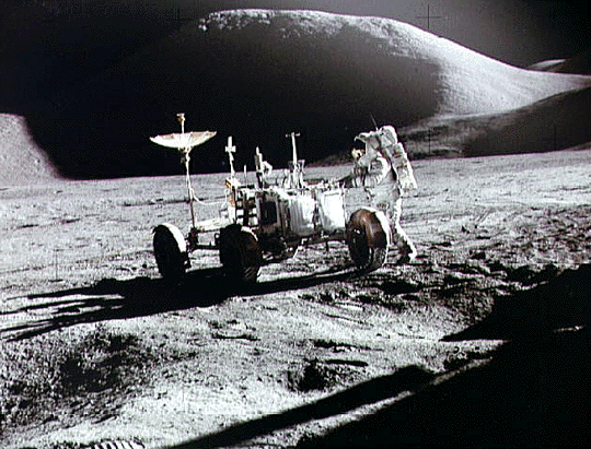 An astronaut works with the lunar rover on the moon. Image credit NASA