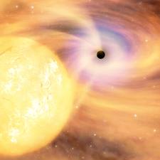 An artistic representation of a black hole sucking matter off a star. Image credit Daily Galaxy.